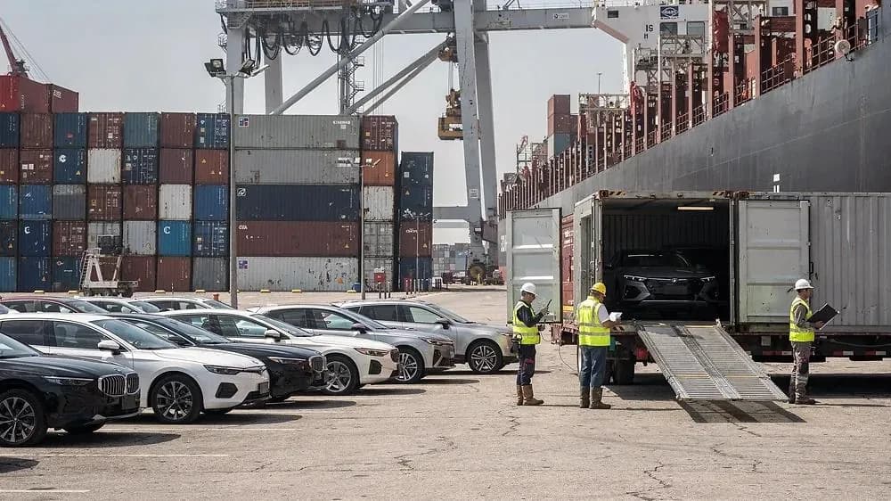 Vehicles being loaded into containers at a Chinese export port